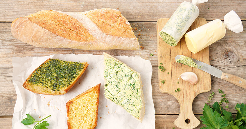 Garlic bread freshly coated and grilled on paper